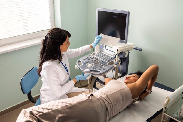 A doctor examining a person on a bed in Louisville, KY