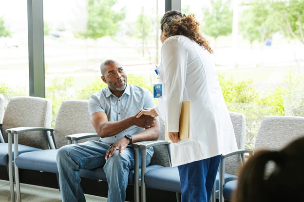 A specialist shakes mans hand at Kentucky office