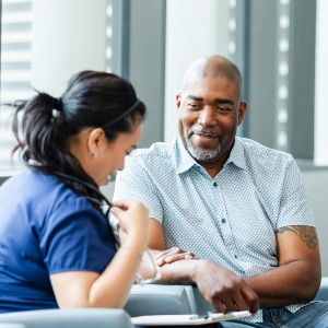 medical professional talking with adult patient in Louisville, Kentucky office